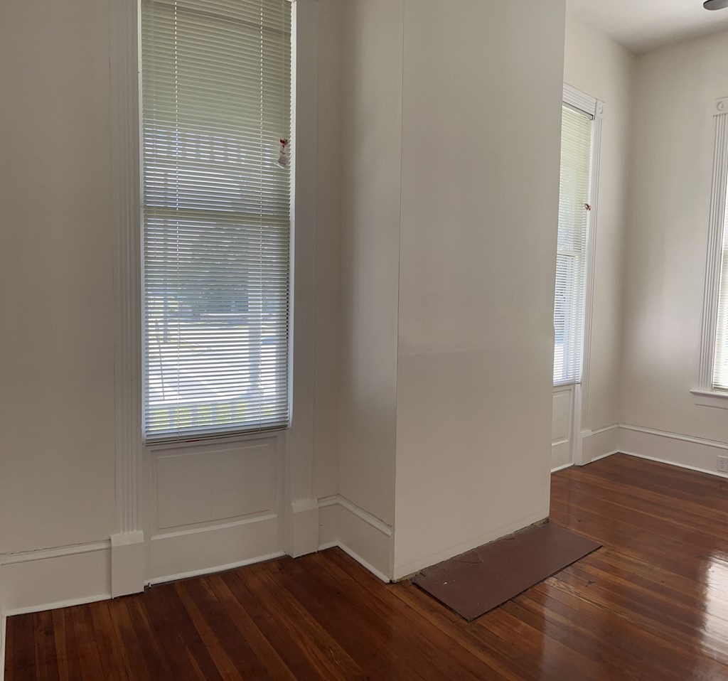 1301 18th Street, Unit A Columbus, GA 31901 - Photo 9 of 21 an empty room with wooden floor and windows
