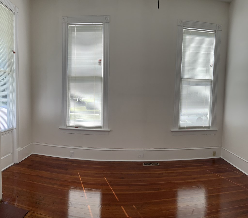 1301 18th Street, Unit A Columbus, GA 31901 - Photo 10 of 21 a view of a room with wooden floor and windows in it