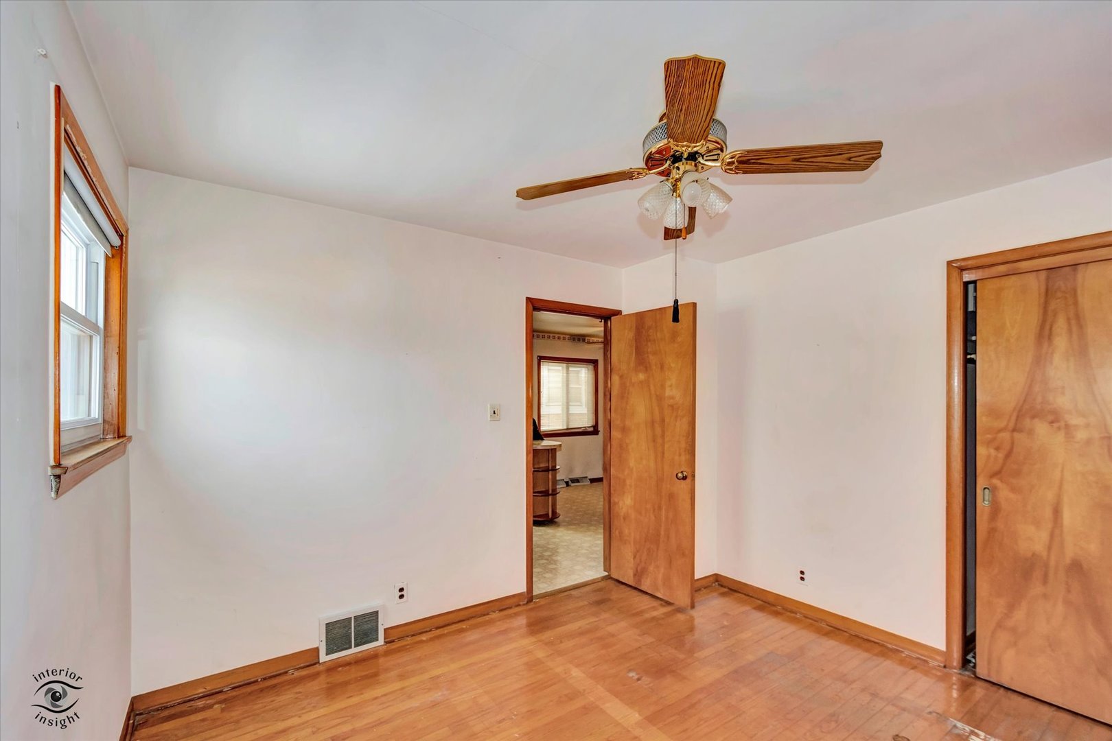 6049 South Mobile Avenue Chicago, IL 60638 - Photo 13 of 26 an empty room with closet and a chandelier fan