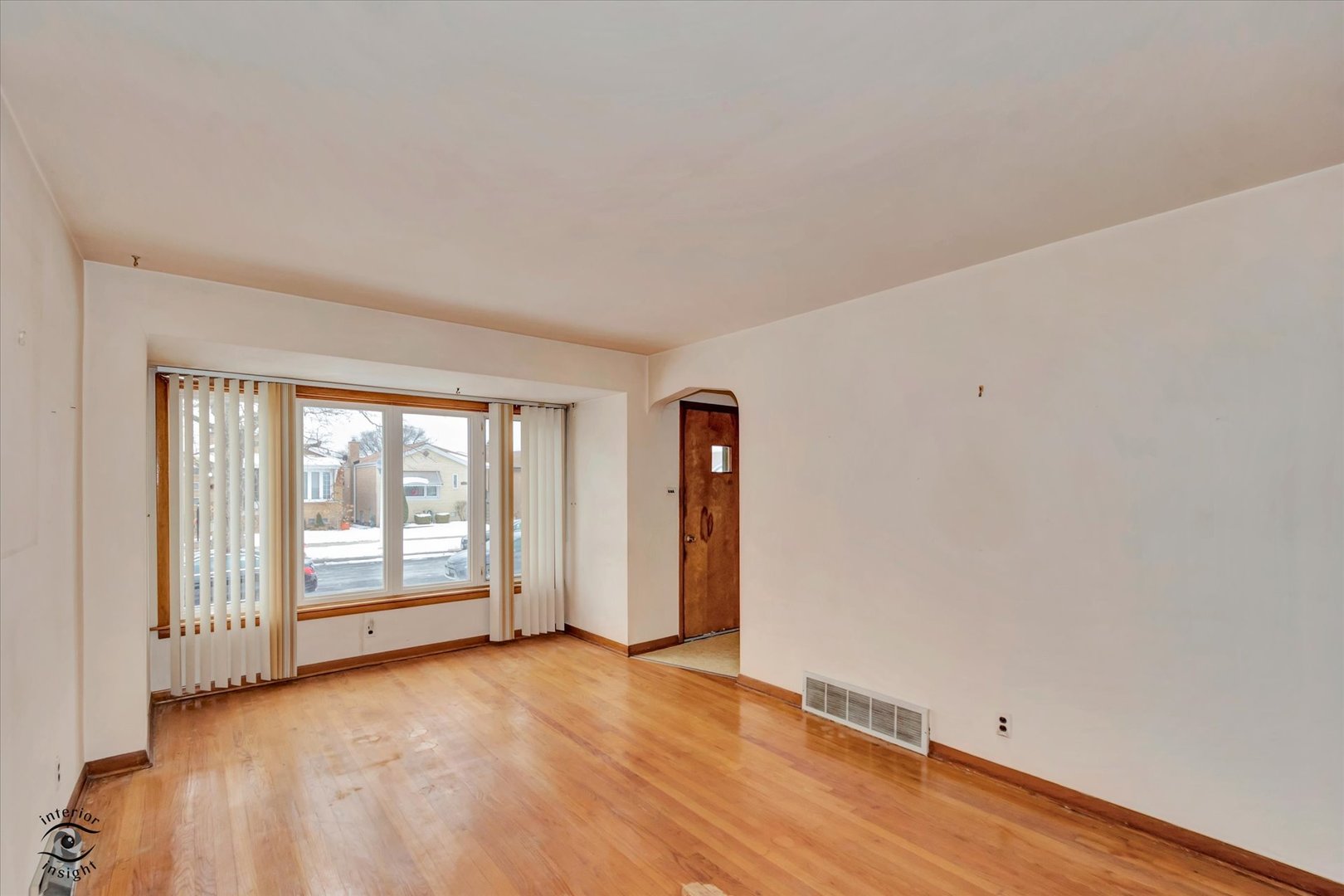 6049 South Mobile Avenue Chicago, IL 60638 - Photo 2 of 26 an empty room with wooden floor and windows