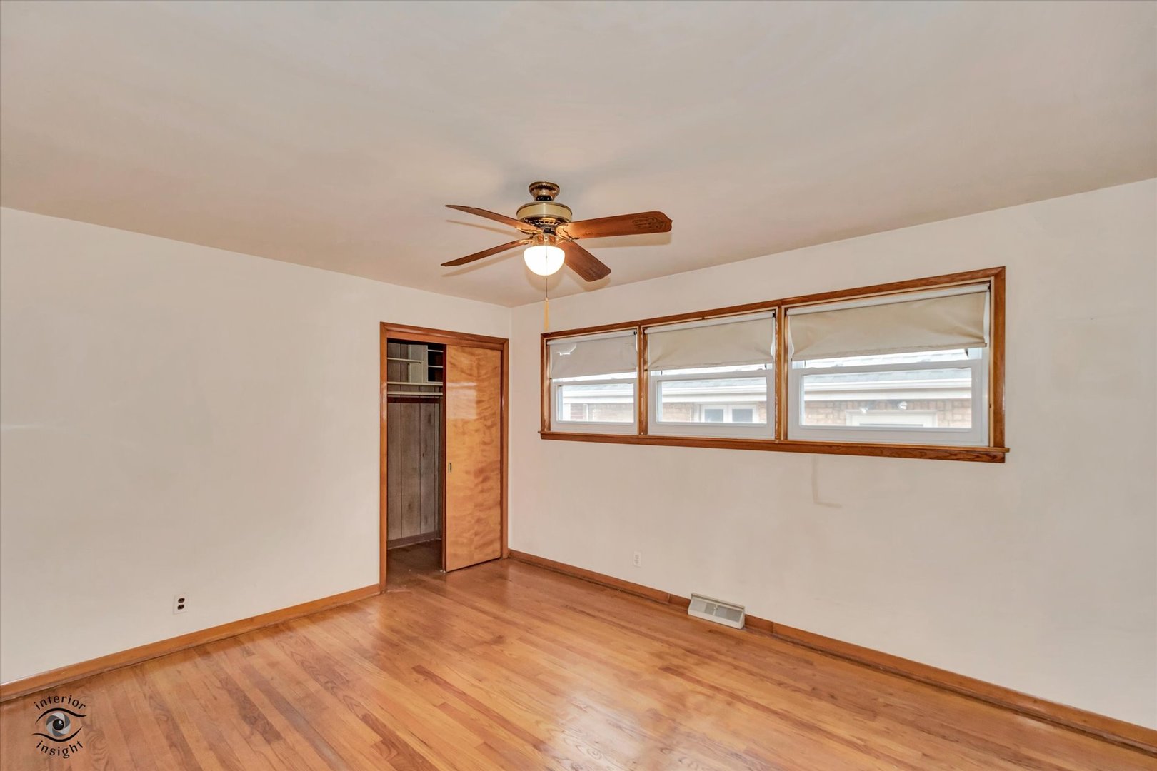 6049 South Mobile Avenue Chicago, IL 60638 - Photo 8 of 26 a view of an empty room with wooden floor and a window