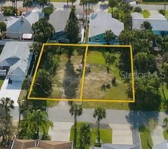 an aerial view of a residential houses with yard