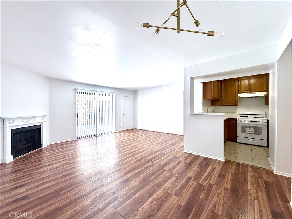 13512 Moorpark Street, Unit 103 Sherman Oaks, CA 91423 - Photo 4 of 10 a view of empty room with wooden floor and kitchen