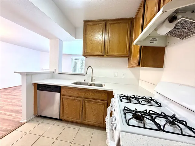 a kitchen with a sink appliances and cabinets
