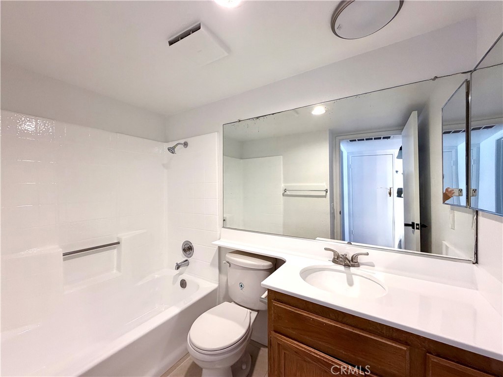 13512 Moorpark Street, Unit 103 Sherman Oaks, CA 91423 - Photo 10 of 10 a bathroom with a granite countertop sink toilet a mirror and shower