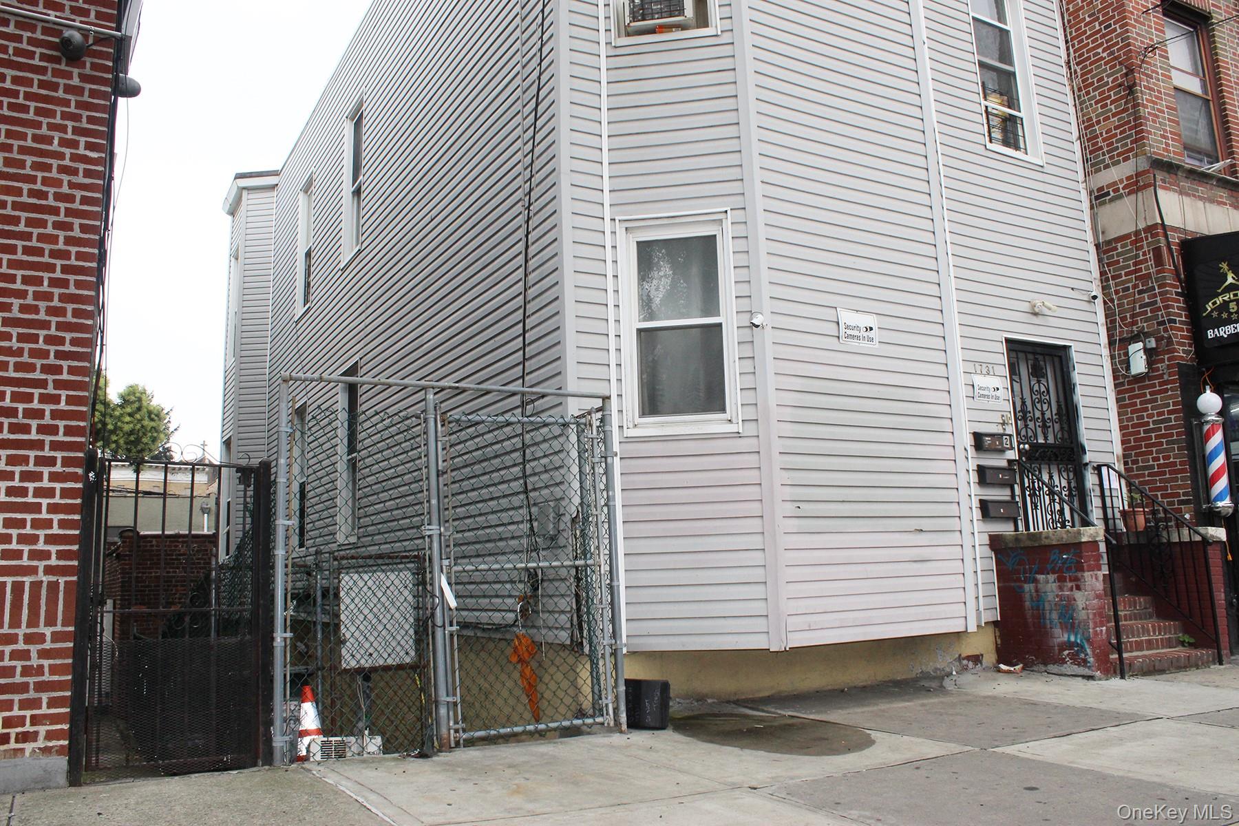 View of side of property with a gate