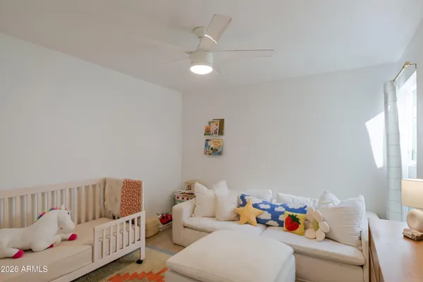 a bedroom with a bed and a large window