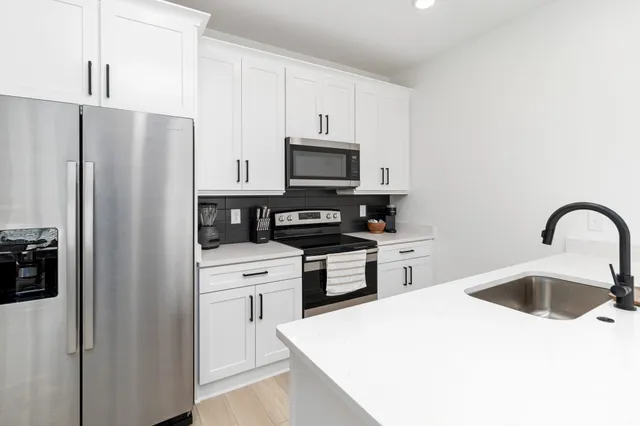 a kitchen with a sink and a refrigerator