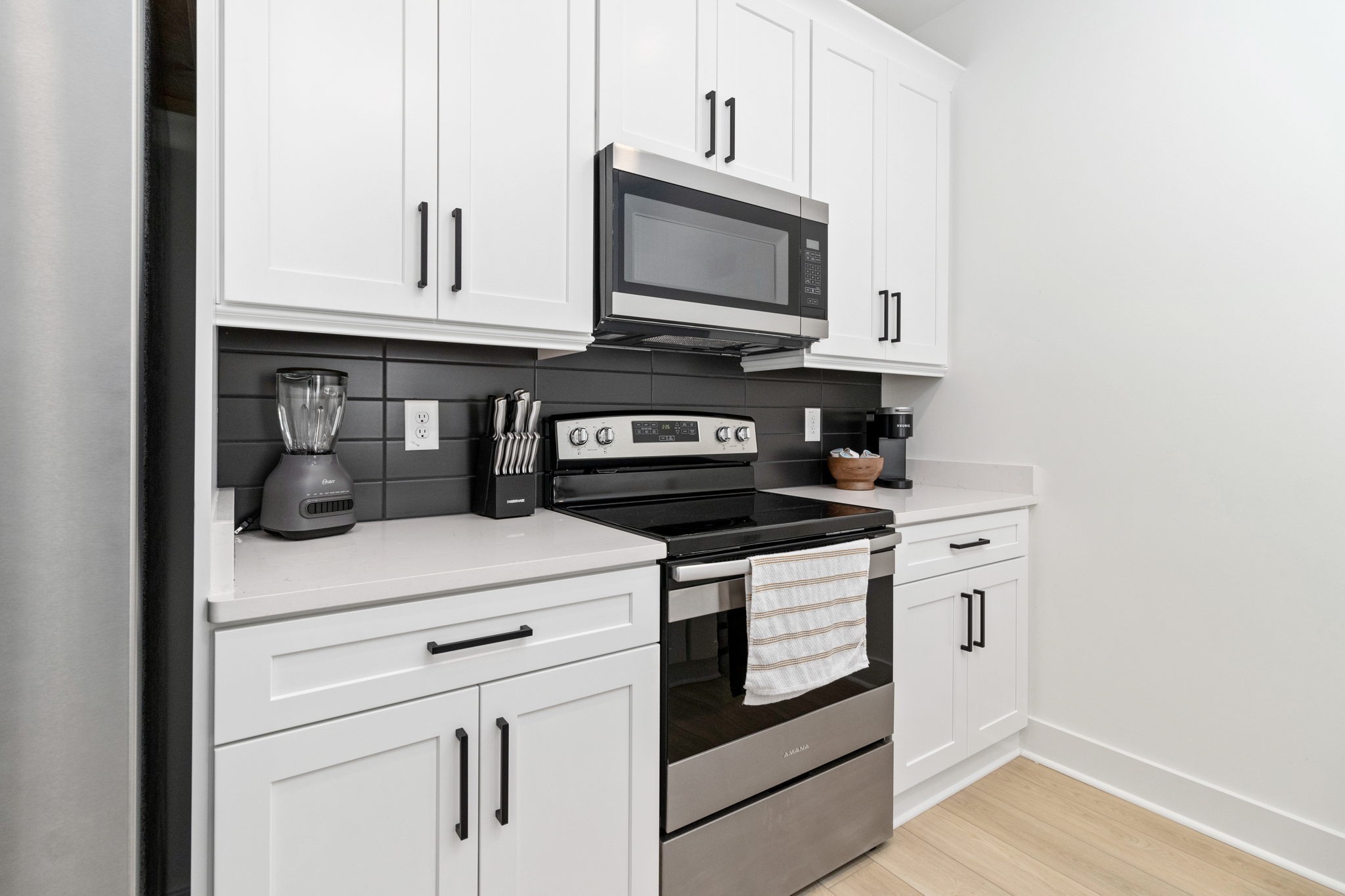 725 Hornbuckle Road, Unit B2 Clarksville, TN 37043 - Photo 12 of 31 a kitchen with stainless steel appliances granite countertop a stove a microwave and cabinets
