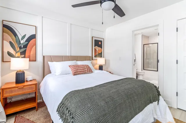 a bedroom with a bed and a flat screen tv