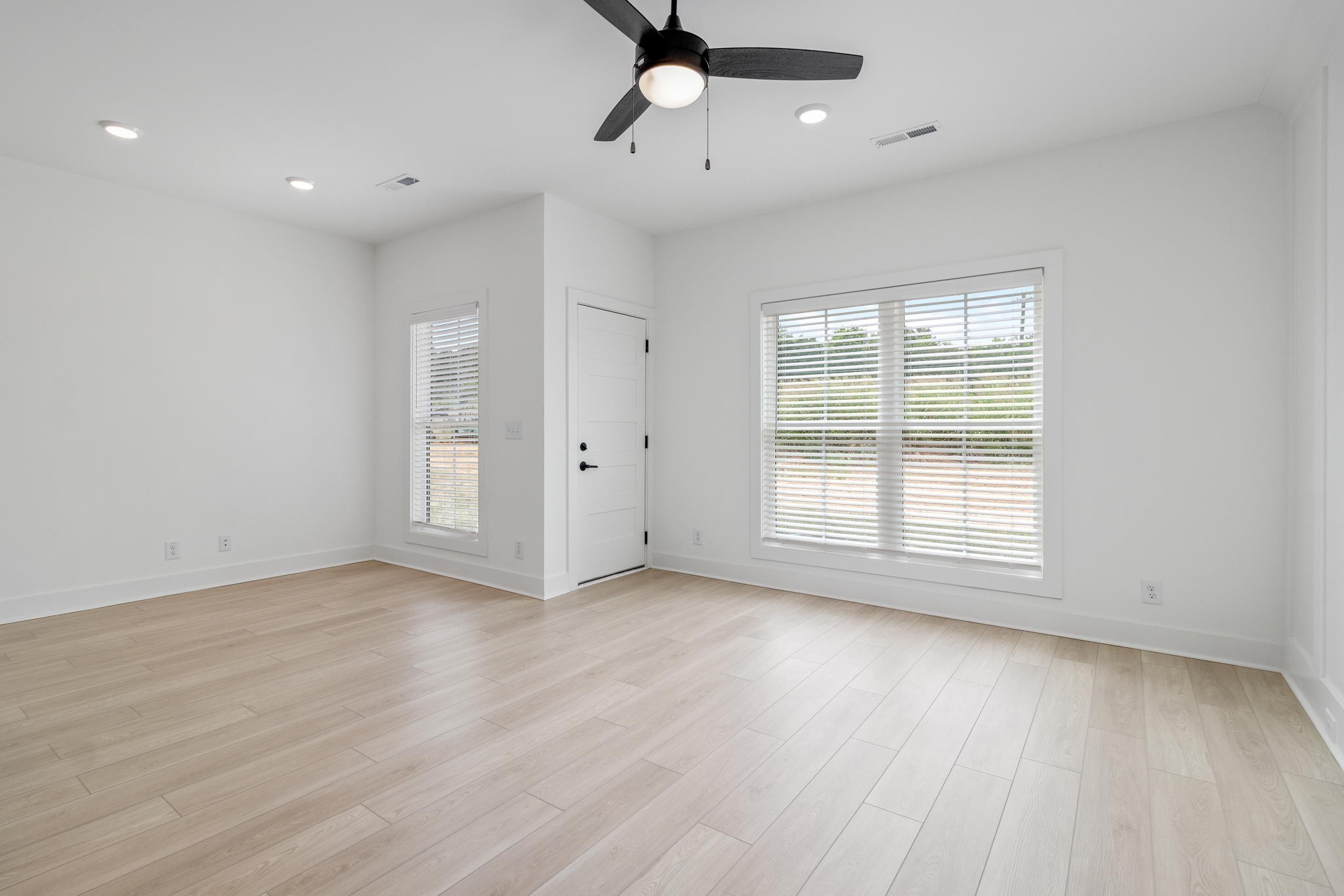 725 Hornbuckle Road, Unit B2 Clarksville, TN 37043 - Photo 8 of 31 an empty room with wooden floor ceiling fan and windows