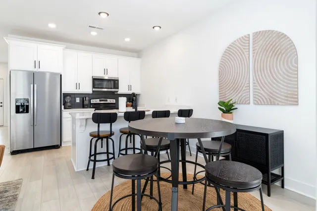 a kitchen with stainless steel appliances granite countertop a stove a microwave and cabinets