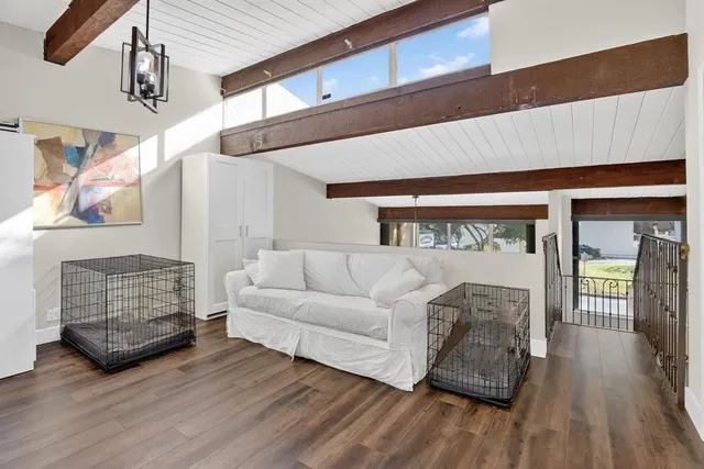an aerial view of residential houses with outdoor space and trees