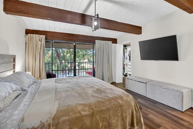 an aerial view of residential houses with outdoor space and trees