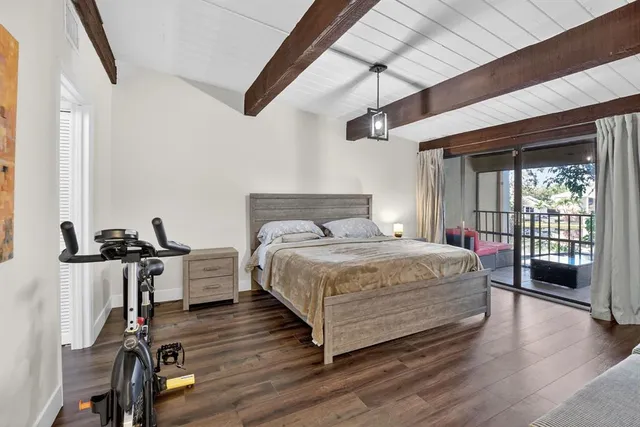 an aerial view of residential houses with outdoor space and trees