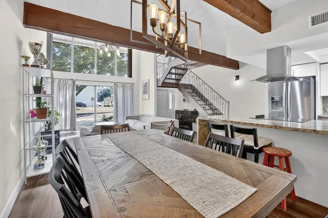 a kitchen with stainless steel appliances granite countertop a sink and wooden cabinets