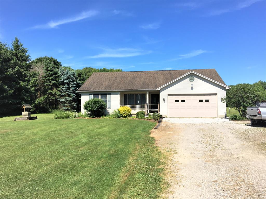 23273 Fry Road Venango, PA 16440 - Photo 1 of 74 a front view of a house with a yard and garage