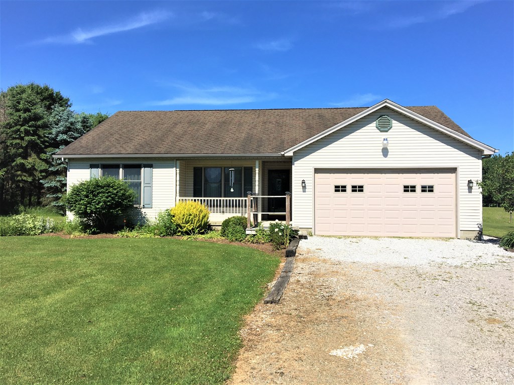 23273 Fry Road Venango, PA 16440 - Photo 2 of 74 a front view of a house with a yard and garage