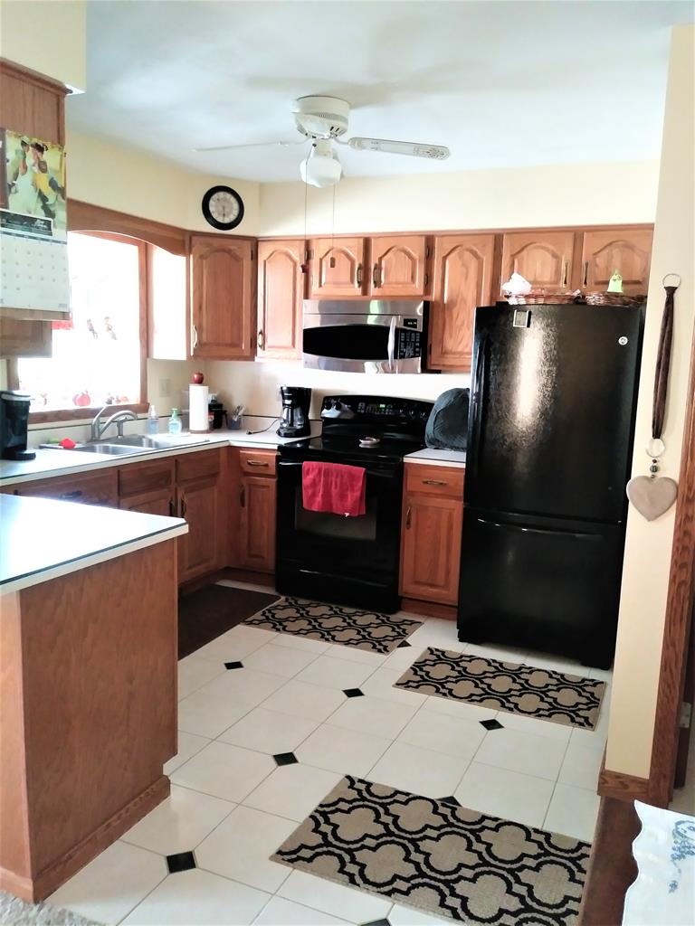 23273 Fry Road Venango, PA 16440 - Photo 30 of 74 a kitchen with stainless steel appliances kitchen island granite countertop a sink stove and refrigerator