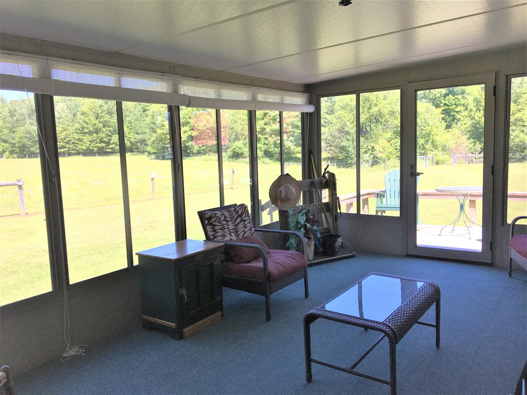 23273 Fry Road Venango, PA 16440 - Photo 54 of 74 a living room with furniture and a floor to ceiling window