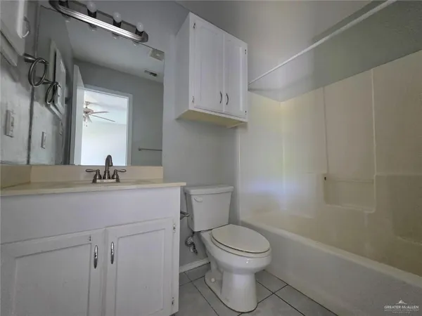 a bathroom with a toilet sink a mirror and vanity