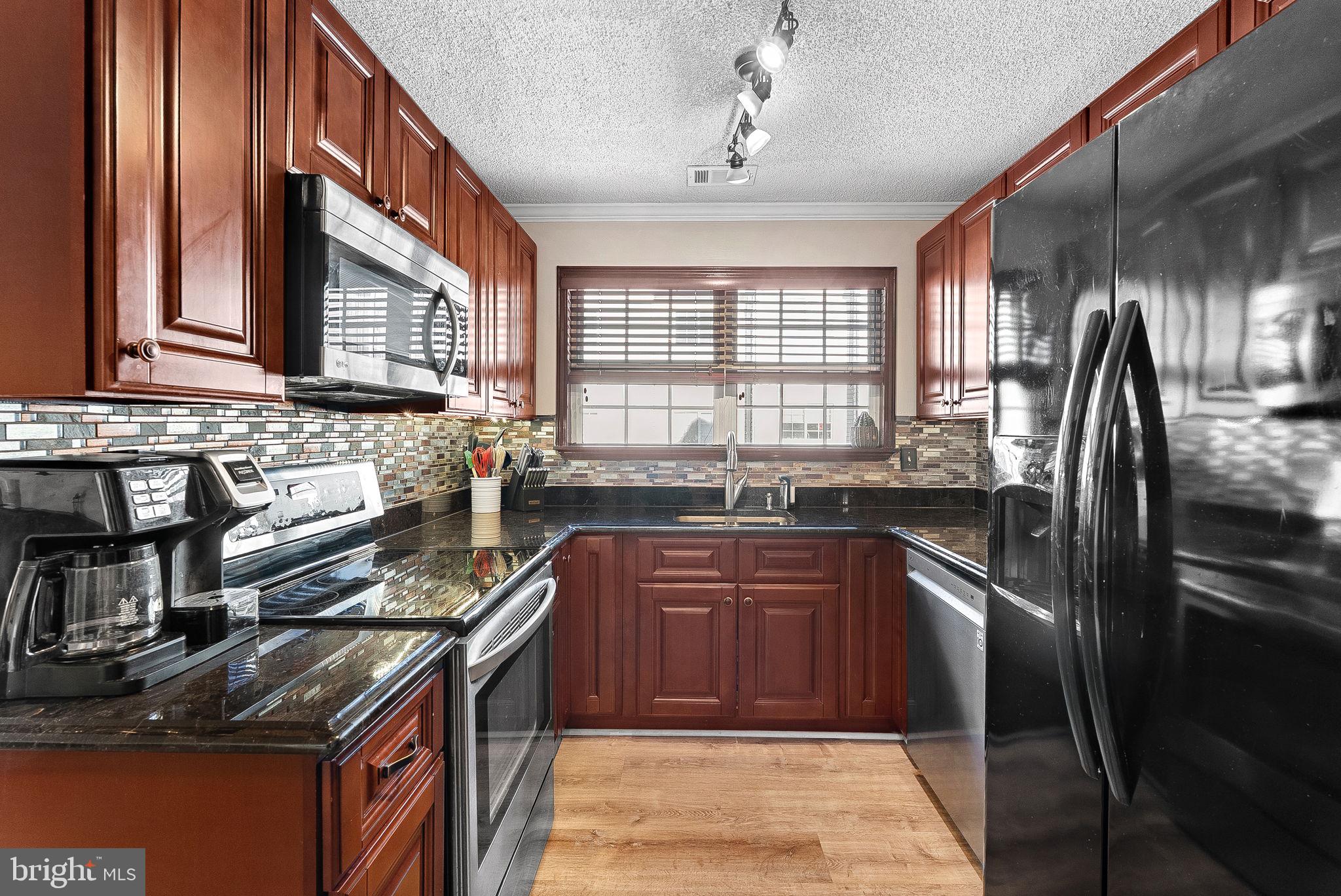 1115 Huntmaster Terrace Northeast, Unit 202 Leesburg, VA 20176 - Photo 13 of 33 Lovely backsplash and under cabinet lighting.