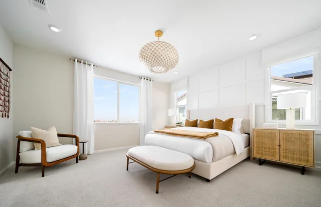 a bedroom with a bed and a chair