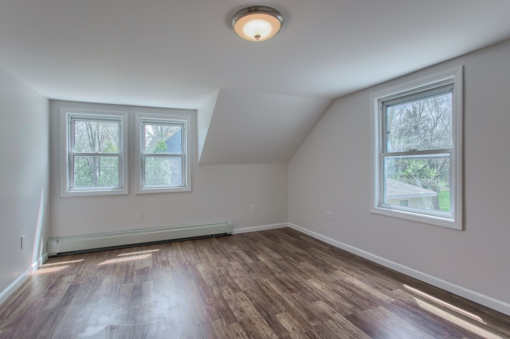 18 South Martin Road Amesbury, MA 01913 - Photo 17 of 30 an empty room with wooden floor and windows