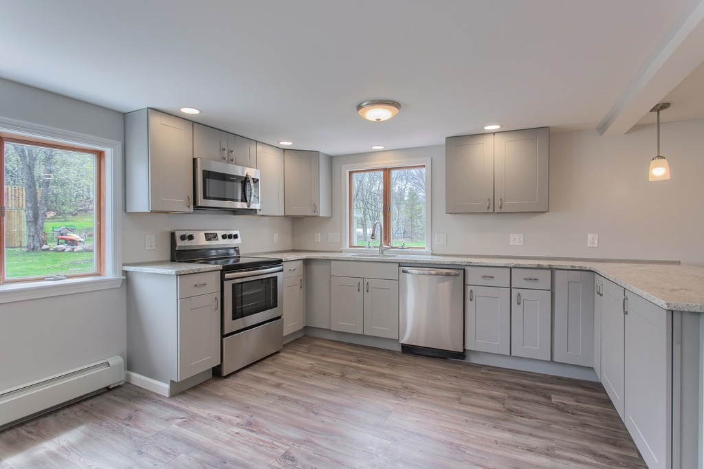18 South Martin Road Amesbury, MA 01913 - Photo 3 of 30 a kitchen with cabinets stainless steel appliances a sink and a window