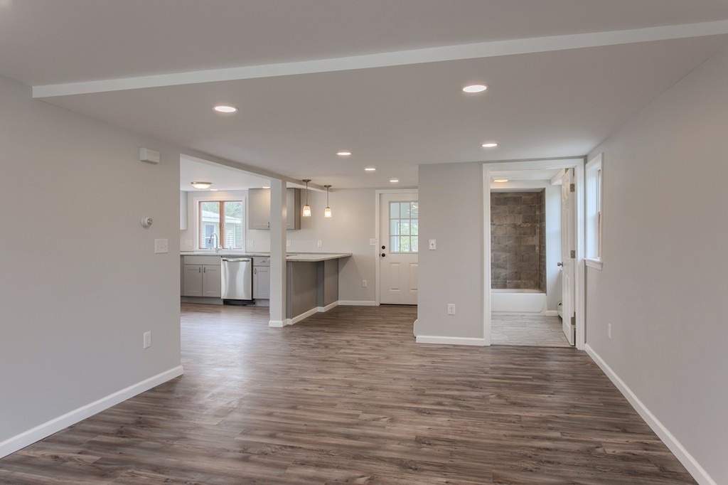 18 South Martin Road Amesbury, MA 01913 - Photo 8 of 30 a view of an empty room with wooden floor and kitchen