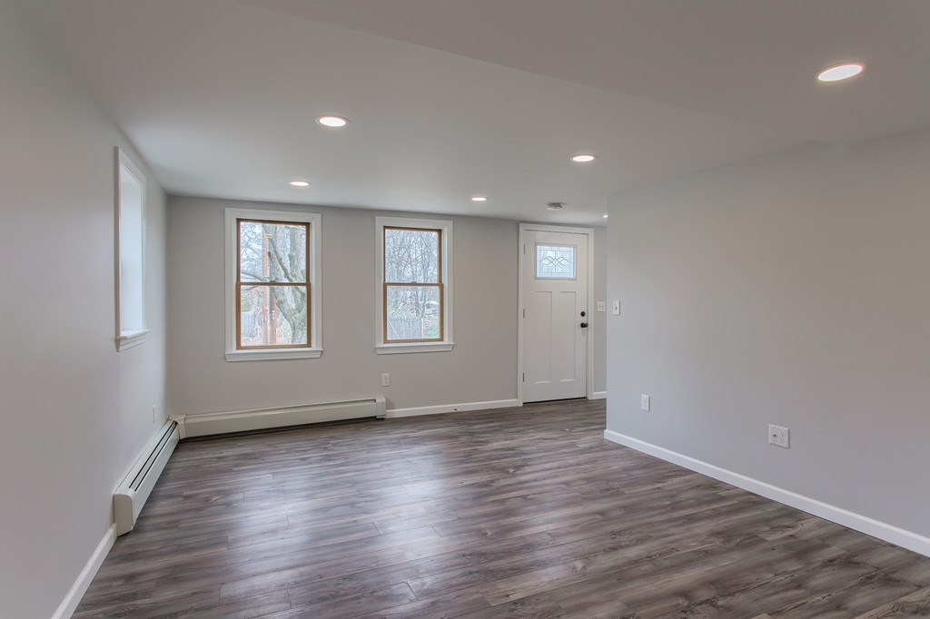 18 South Martin Road Amesbury, MA 01913 - Photo 10 of 30 an empty room with wooden floor and windows