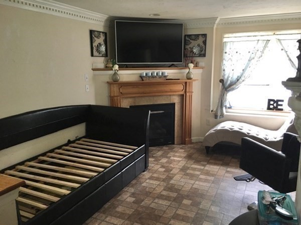 a living room with a flat screen tv and a fireplace