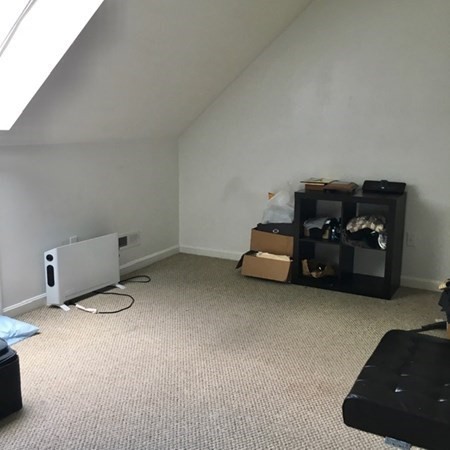 997 Middlesex Street, Unit 3 Lowell, MA 01851 - Photo 11 of 11 a living room with furniture and a lamp