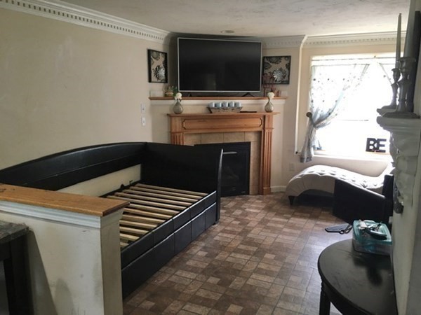 997 Middlesex Street, Unit 3 Lowell, MA 01851 - Photo 2 of 11 a bedroom with a bed and a flat screen tv