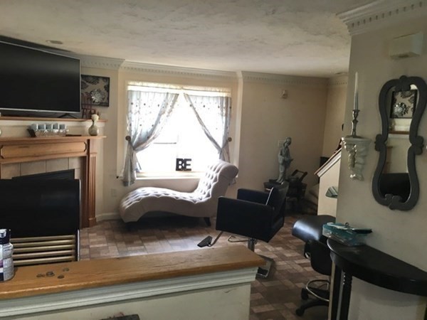 997 Middlesex Street, Unit 3 Lowell, MA 01851 - Photo 3 of 11 a living room with furniture and a flat screen tv