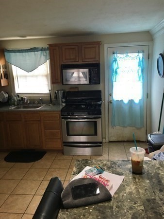 997 Middlesex Street, Unit 3 Lowell, MA 01851 - Photo 7 of 11 a living room with furniture and a flat screen tv
