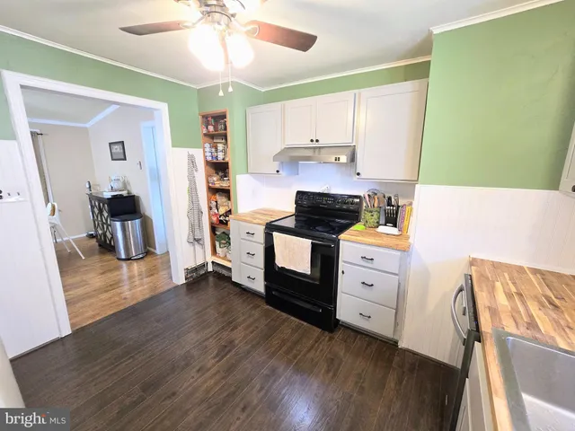 a kitchen with stainless steel appliances a stove refrigerator sink and cabinets