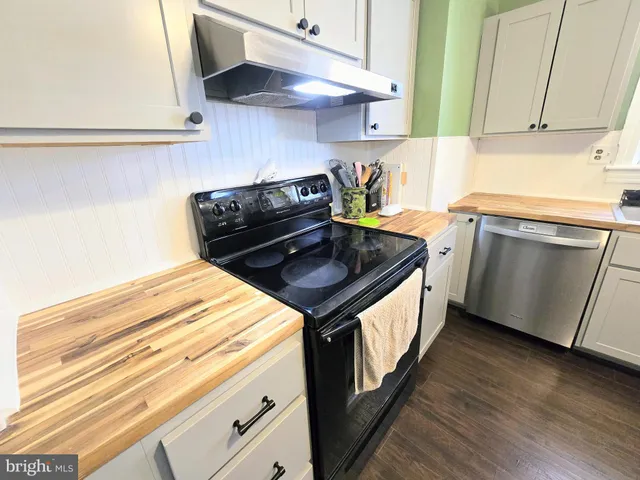 a kitchen with stainless steel appliances granite countertop a stove and a sink