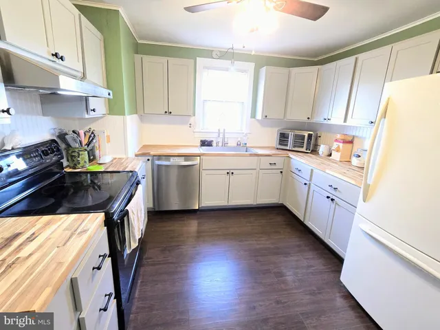 a kitchen with a sink a stove and cabinets