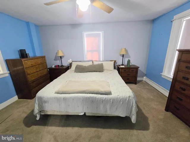 a bedroom with bed and wooden floor