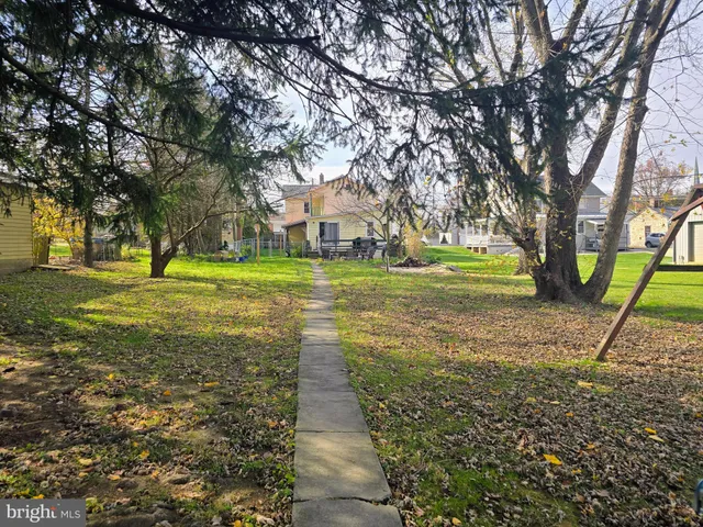 a backyard of a house with lots of green space and trees