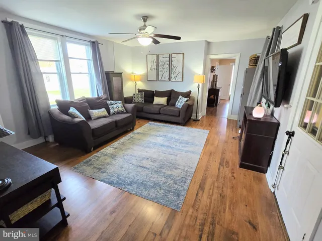 a living room with furniture window and wooden floor