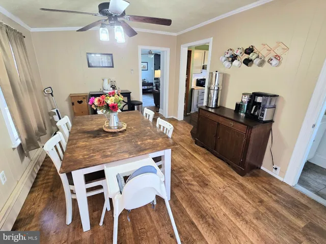 a view of a dining room with furniture and wooden floor