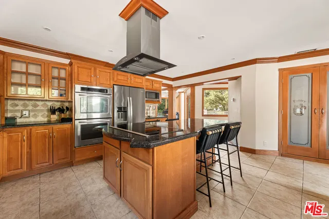 a bedroom with a bed and a glass walk in closet