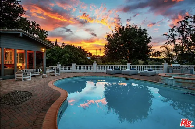 a view of a white building with a swimming pool