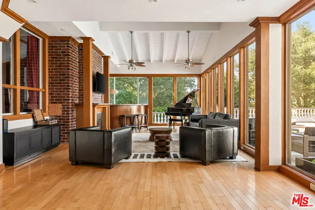 a kitchen with stainless steel appliances wooden cabinets a sink and a large window