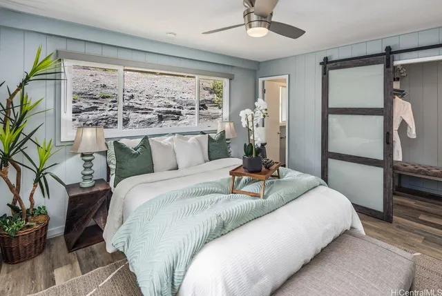 a bedroom with bed and a large window