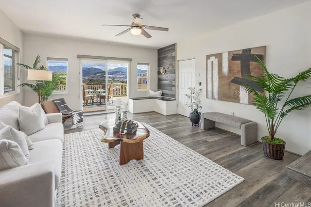 a living room with furniture and a potted plant