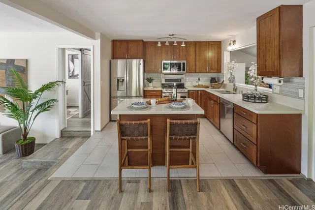 a kitchen with stainless steel appliances granite countertop a sink stove and cabinets