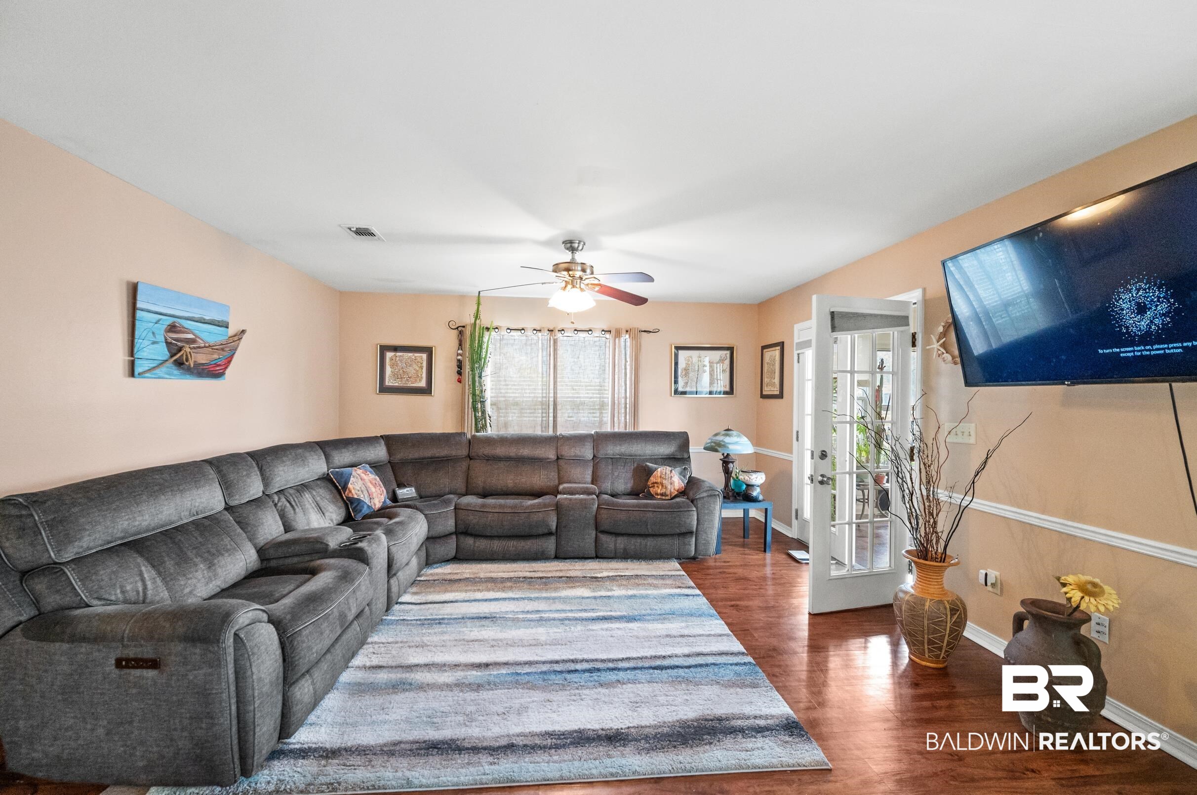 1192 Ridgewood Drive Lillian, AL 36549 - Photo 10 of 36 Living room featuring ceiling fan and dark hardwood / wood-style floors
